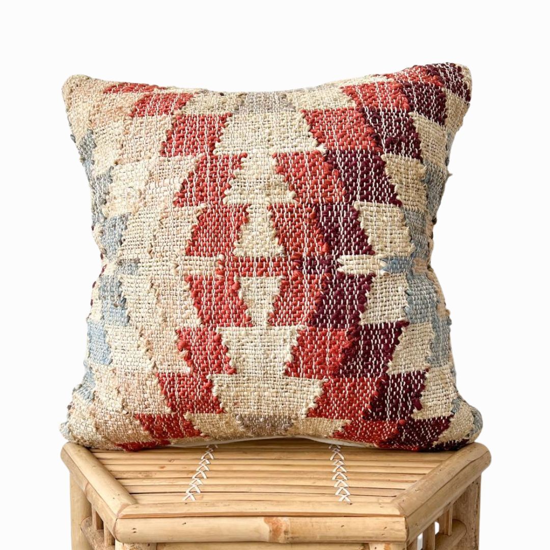 Close-up texture of the Tira cushion cover showing the dense Punja hand-weaving technique using natural jute and organic cotton fibers.