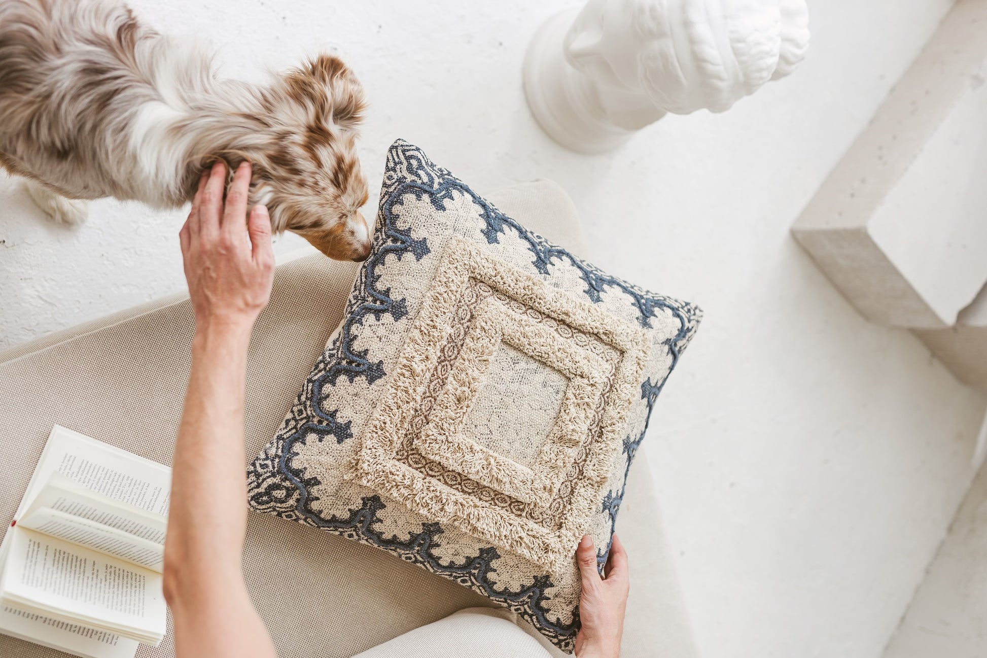 Close-up detail of artisanal tufted fringes and traditional block print patterns on organic cotton.