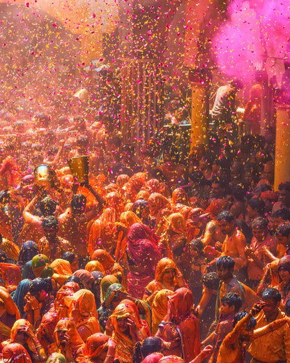 Traditional Phoolon Ki Holi celebration with raining flower petals. Showcasing the natural origin and inspiration behind our upcycled temple flower colors.